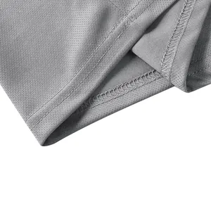 Close-up of quick-dry fabric texture and double-stitched hem on a gray polo shirt
