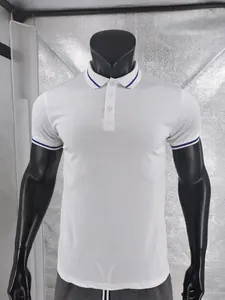 Detailed view of white quick-dry polo shirt with blue striped collar and cuffs trim