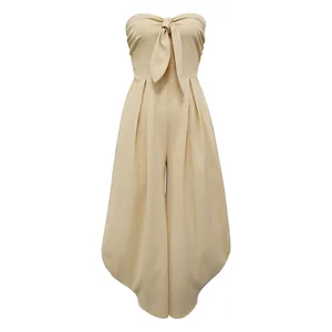 Detailed front view of a beige strapless jumpsuit with tie-front detail and wide legs