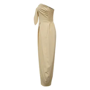 Detailed side view of apricot strapless jumpsuit featuring shoulder knot and smocked back