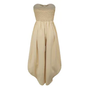 Back view of a beige strapless jumpsuit featuring a smocked bodice and wide legs.