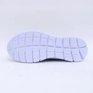 Bottom view showing the textured white anti-slip outsole of casual slip-on sneakers.