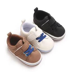 Top view of three pairs of infant walking shoes in black, white, and brown leather styles