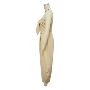 Detailed side view of a beige strapless tie-front wide-leg jumpsuit on a mannequin