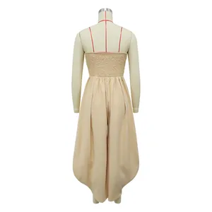 Back view of a beige strapless jumpsuit featuring a smocked bodice and relaxed fit.