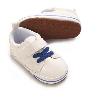 Detailed view of cream baby walking shoes with blue laces and non-slip soft soles.