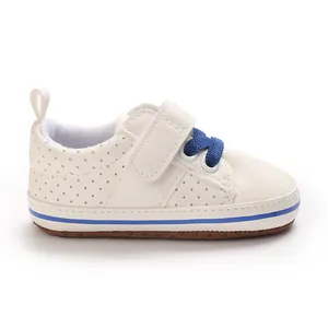 Side view of cream baby walker shoe with blue laces and soft anti-slip sole