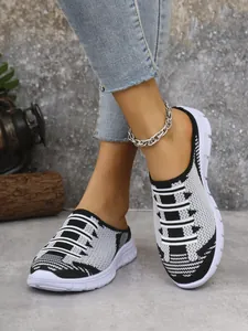 Close-up of stylish black and white fly-woven pattern on breathable women's mules