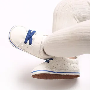 Detailed close-up view of cute baby walking shoes with blue laces and soft sole