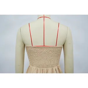 Close-up of the smocked back detail on a beige strapless solid color jumpsuit