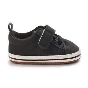 Close-up side view of black baby walking shoes with velcro strap and soft non-slip sole