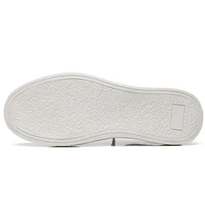 Detail view of a white slip-on sneaker outsole featuring durable rubber anti-slip texture