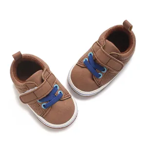 Brown soft-sole baby walking shoes with blue laces and Velcro strap for 0-1 year old.