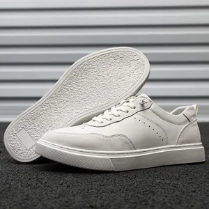 Side view detail of white suede and leather minimalist sneakers with textured sole
