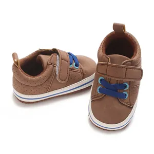 Detailed view of brown baby walking shoes with blue laces and velcro straps.
