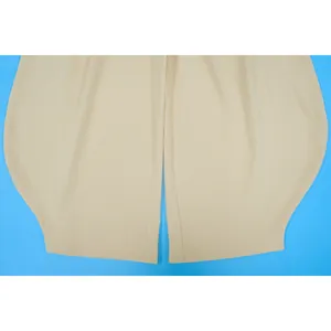 Detail of beige solid color jumpsuit featuring premium crinkle fabric texture.