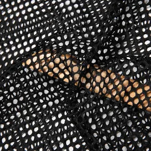 Close-up macro detail of breathable black mesh fishnet fabric for men's see-through T-shirt