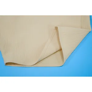Macro view showing the textured fabric and clean hem of a sexy beige bandeau jumpsuit