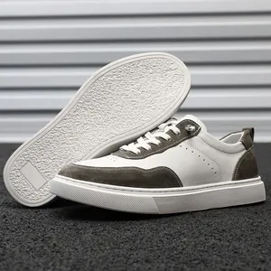 Detailed view of premium white and brown suede low-top casual sneakers with rubber sole