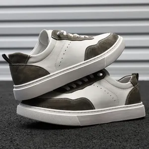 Detailed view of men's retro low-top sneakers in white leather and brown suede.