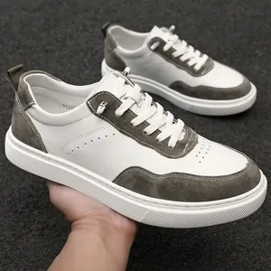 Detailed side view of retro men's casual sneakers with white leather and grey suede accents