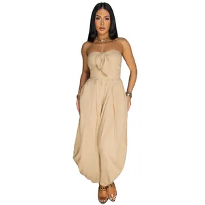 Detailed view of the textured fabric and bow-tie chest on this beige strapless jumpsuit