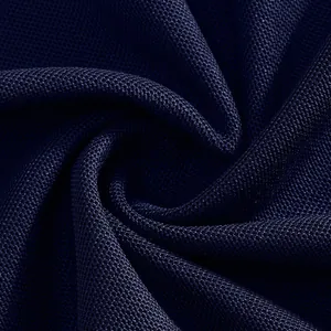 Macro view of navy blue breathable pique knit fabric texture for premium golf polo shirts