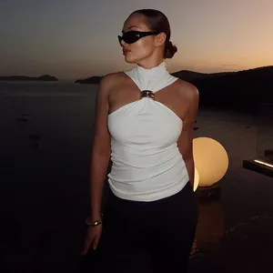 Elegant white halter neck tank top featuring a chic gold metal ring detail on a model.