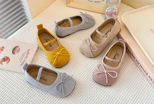 Detailed macro view showcasing various colors of children's suede Mary Jane bow shoes