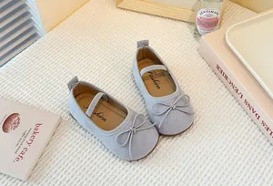 Detail view of toddler girl's light blue Mary Jane shoes with delicate bow accents