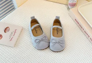 Close-up of grey girl's Mary Jane shoes with elegant bowknot detail and soft soles.