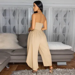 Elegant back view of a sexy khaki strapless wide-leg jumpsuit on a female model