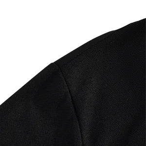 Macro detail of the breathable mesh fabric and high-quality seam on a black polo shirt