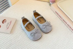 Top-down view of grey suede children's Mary Jane shoes with delicate bow detail