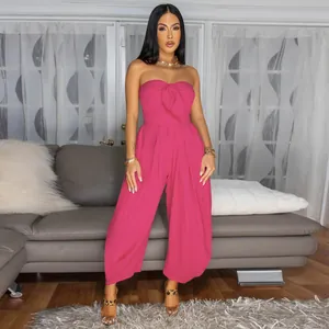 Detailed view of a sexy pink strapless jumpsuit with bow-knot detail and wide-leg design.
