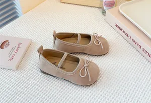 Detailed view of beige suede Mary Jane shoes for girls with elegant bow accents