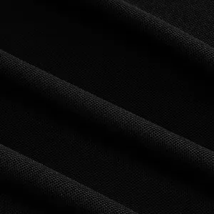 Macro detail view of breathable black pique knit fabric for sports golf polo shirts