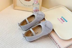 Detailed macro view of children's soft purple suede Mary Jane shoes with cute bow details