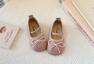 Close-up of pink Mary Jane shoes for girls featuring a delicate bow and soft suede finish