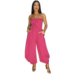 Detailed view of a sexy strapless rose pink jumpsuit with front bow knot detail.