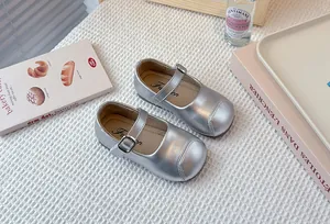 Detailed top-down view of silver metallic Mary Jane shoes for girls with buckle strap
