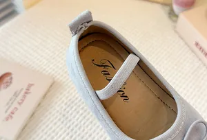 Macro view of light blue children's Mary Jane shoe interior and soft leather insole