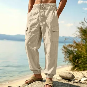 Loose men's linen cargo pants with multiple pockets and drawstring waist at the beach