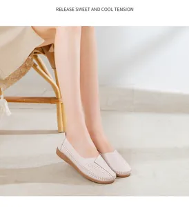 Close-up of beige leather loafers on model, showcasing comfort and stitching detail.