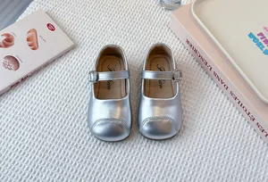 Shiny silver metallic Mary Jane shoes for girls featuring a soft sole and buckle strap detail
