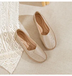 Detailed view of comfortable beige women's loafers with breathable laser-cut patterns.