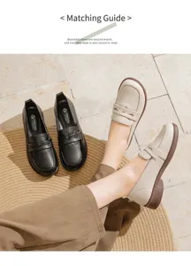 Comfortable cream and black leather loafers styled with casual trousers on a stone floor