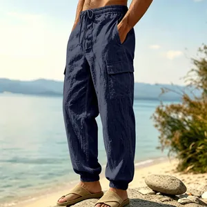 Close-up detail of men's loose linen cargo jogger pants with pockets and drawstring