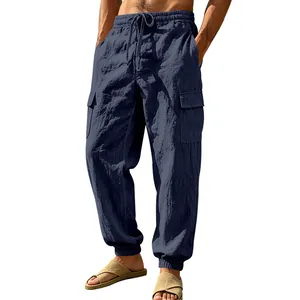 Detail of navy blue men's linen cargo pants with elastic drawstring and side pockets.
