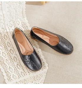 Top view detail of black leather loafers for elderly women with textured toe design